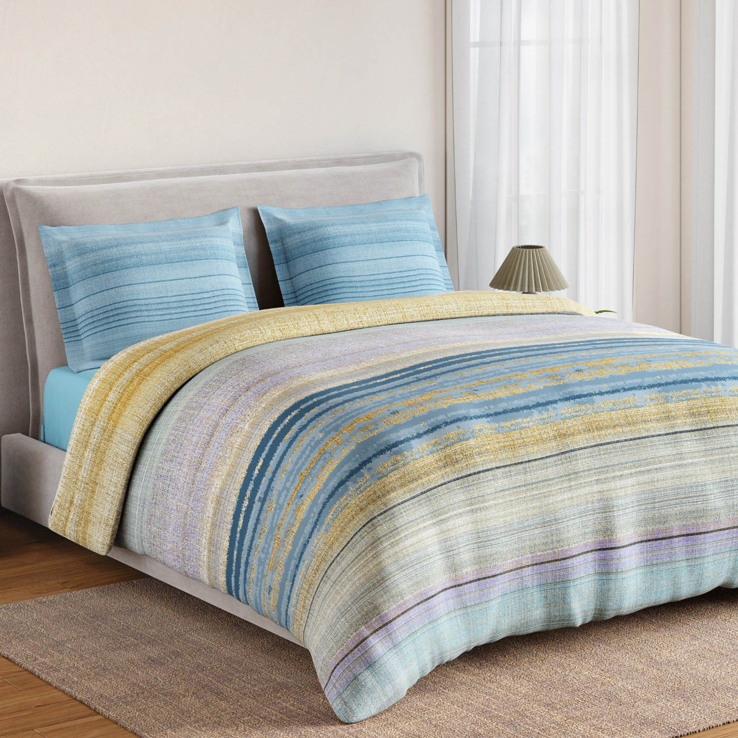 Bed with striped bedding and blue pillows in a bedroom setting